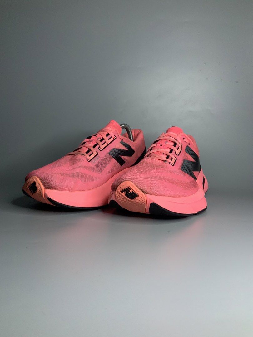 New Balance FuelCell Rebel v4 (Category: Sneakers) located in Cavite. Submitted by kalye_footwear (Listing ID 1465335037, Image 3). Description: - Brand/Model: New Balance FuelCell Rebel v4 - Color: Bright pink with black & silver branding and neon green insoles - Size: Us 10.5, Euro 44.5, 28.5 - Features: Breathable mesh upper, matching pink laces, cushioned midsole - Condition: Minimal signs of wear on uppers and soles - Perfect for: Running, w