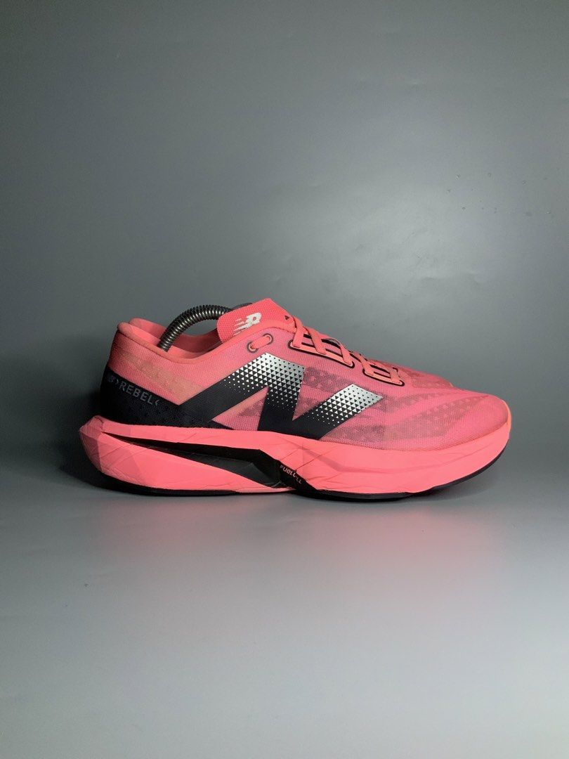 New Balance FuelCell Rebel v4 (Category: Sneakers) located in Cavite. Submitted by kalye_footwear (Listing ID 1465335037, Image 2). Description: - Brand/Model: New Balance FuelCell Rebel v4 - Color: Bright pink with black & silver branding and neon green insoles - Size: Us 10.5, Euro 44.5, 28.5 - Features: Breathable mesh upper, matching pink laces, cushioned midsole - Condition: Minimal signs of wear on uppers and soles - Perfect for: Running, w