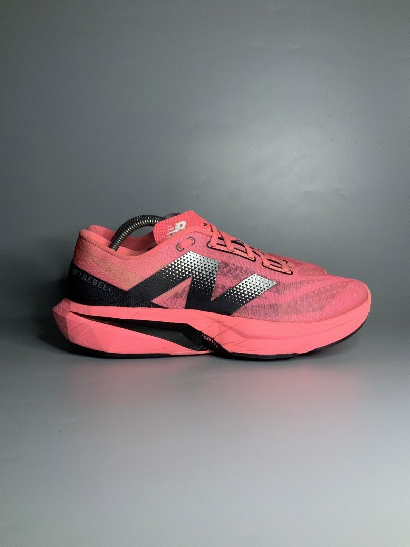 New Balance FuelCell Rebel v4 (Category: Sneakers) located in Cavite. Submitted by kalye_footwear (Listing ID 1465335037, Image 1). Description: - Brand/Model: New Balance FuelCell Rebel v4 - Color: Bright pink with black & silver branding and neon green insoles - Size: Us 10.5, Euro 44.5, 28.5 - Features: Breathable mesh upper, matching pink laces, cushioned midsole - Condition: Minimal signs of wear on uppers and soles - Perfect for: Running, w