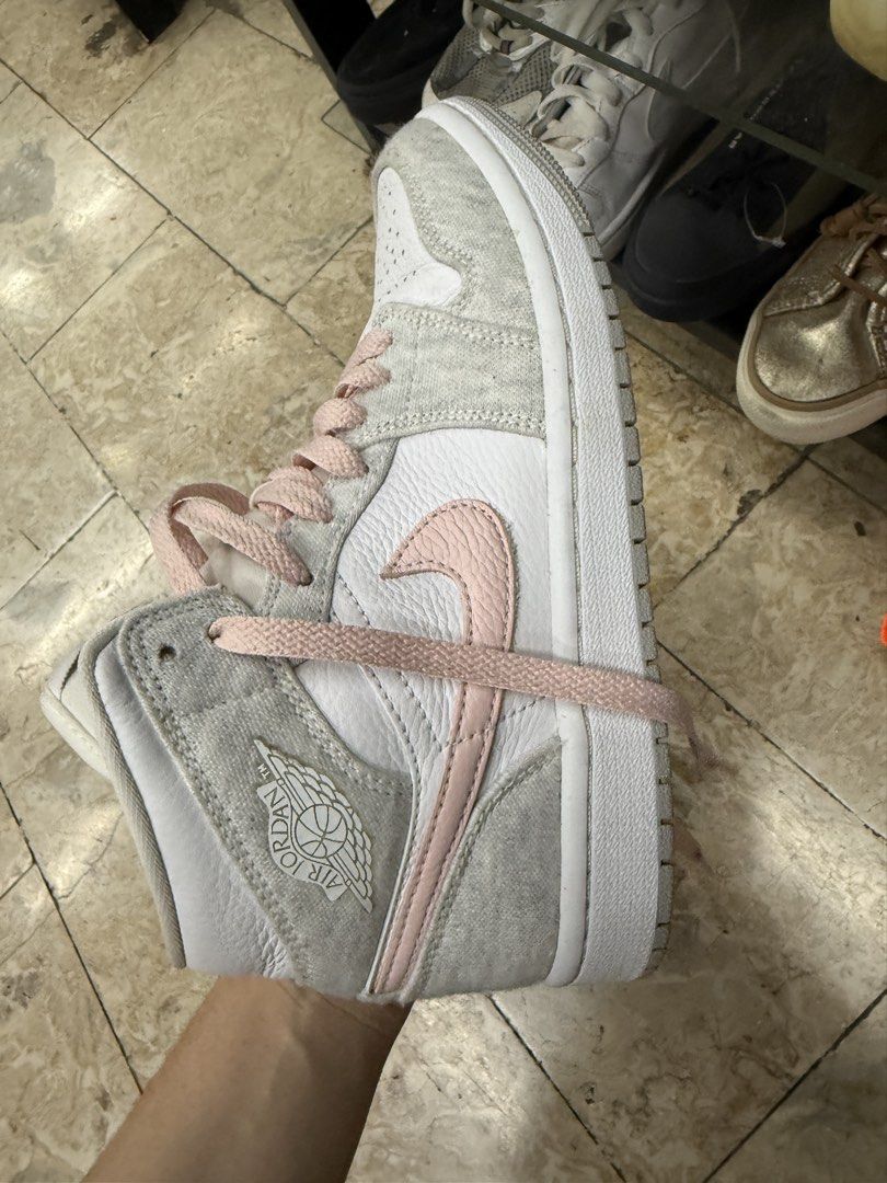 Nike Air Jordan 1 Mid Grey Pink (Category: Sneakers) located in Abucay. Submitted by fastlion.584bdf (Listing ID 1465361613, Image 1). Description: - Brand: Nike Air Jordan 1 Mid - Colorway: White leather base with cozy grey fleece overlays and pastel pink accents (Swoosh, laces, and branding) - Size: 235 / 2.5 (fits approx. US 4Y / EUR 35.5) - Condition: Clean overall, very minimal wear on soles - Features: Classic basketball shoe design with a 