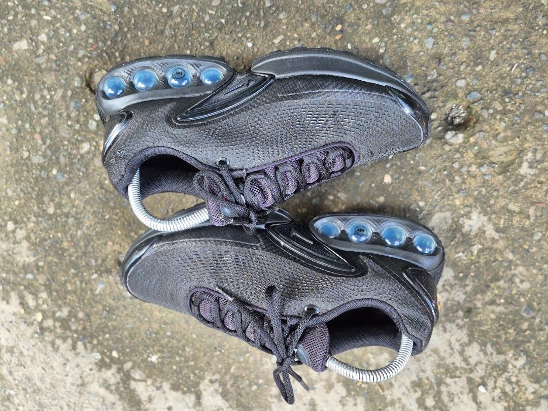 Nike Air Max Dn Black Sneakers (Category: Sneakers) located in Manila. Submitted by kushoenero (Listing ID 1465302415, Image 2). Description: - Model: Nike Air Max Dn - Colorway: All-black with dark blue translucent air bubble units - Upper: Breathable mesh with textured detailing - Details: Traditional lace-up front with metal aglets and subtle Swoosh branding - Comfort: Padded collar and distinctive cushioned heel pillars - Style: Sleek modern 