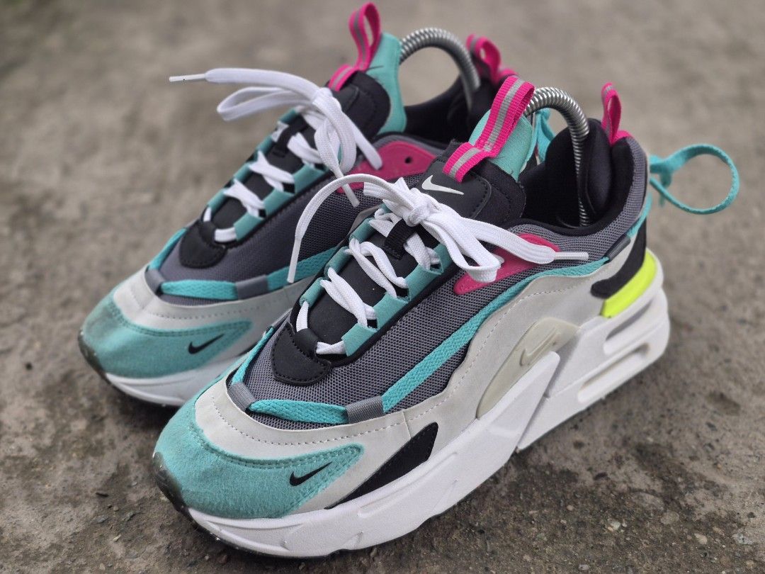 Nike Air Max furyoza (Category: Sneakers) located in Manila. Submitted by kushoenero (Listing ID 1465303020, Image 3). Description: - Brand: Nike Air Max - Colorway: Vibrant teal, pink, grey, and neon yellow panels - Materials: Mesh and suede upper construction with a chunky white foam midsole - Features: Pull tabs at the tongue and heel, white laces installed - Condition: Pre-owned with minor dirt marks on the suede toe box area.
