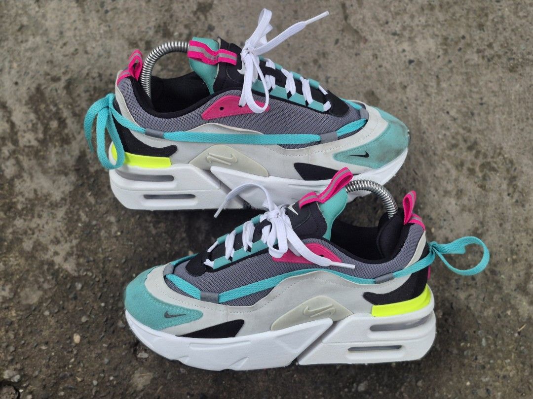 Nike Air Max furyoza (Category: Sneakers) located in Manila. Submitted by kushoenero (Listing ID 1465303020, Image 2). Description: - Brand: Nike Air Max - Colorway: Vibrant teal, pink, grey, and neon yellow panels - Materials: Mesh and suede upper construction with a chunky white foam midsole - Features: Pull tabs at the tongue and heel, white laces installed - Condition: Pre-owned with minor dirt marks on the suede toe box area.