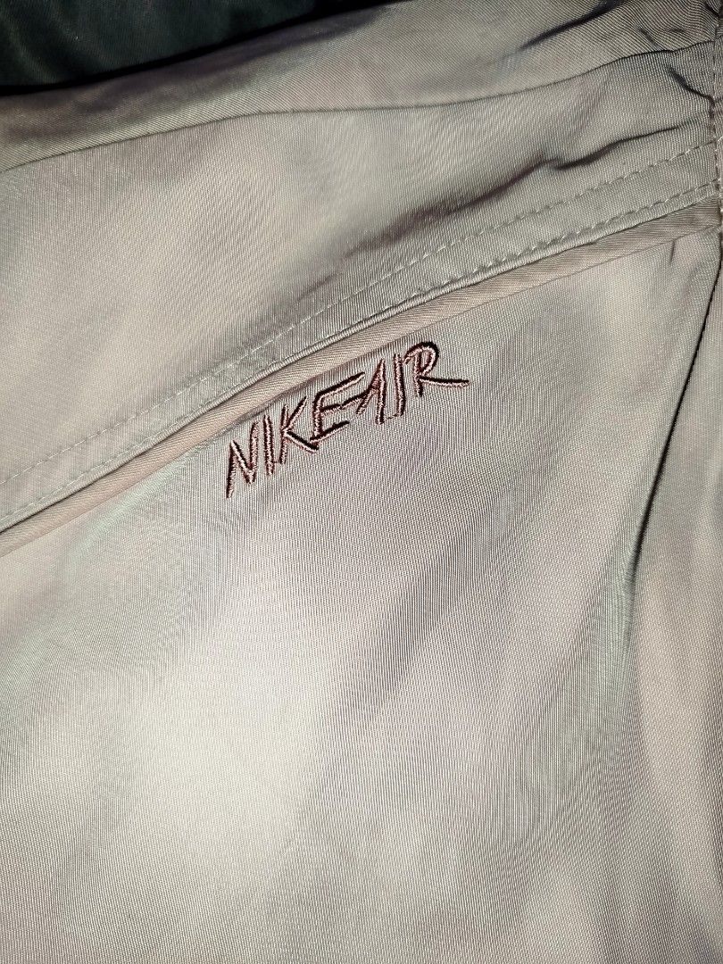 Nike Air Pink Bomber Jacket Size L (Category: Coats, Jackets and Outerwear) located in Quezon City. Submitted by y2k_thriftkid (Listing ID 1465362863, Image 3). Description: Nike Air bomber jacket in pastel pink. Full zip closure with metal Nike pull tab. Large embroidered Nike logo patch on the back. Smaller embroidered Nike Air script on the chest. Ribbed collar, cuffs, and hem. 100 percent polyester shell and lining. Size L tag attached inside
