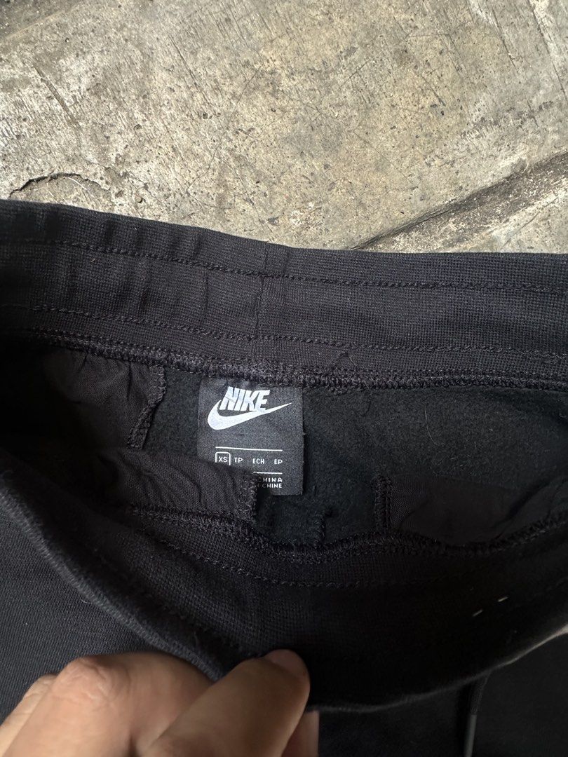 Nike Big Swoosh Black Sweatpants (Category: Joggers) located in Lapu Lapu. Submitted by gabocamaon03138 (Listing ID 1465236259, Image 3). Description: - Brand: Nike - Color: Black with giant white wrap-around Swoosh logo - Size: XS - Material: Super comfy fleece lining - Features: Adjustable drawstring waistband, ribbed ankle cuffs, and a right-side back pocket - Condition: Excellent / Ready to wear - Perfect for: Casual lounging, gym, or streetw