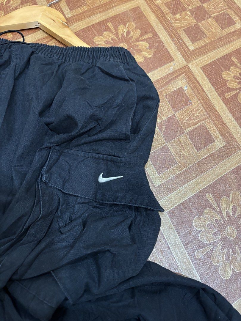 Nike Black Cargo Skirt Size L (Category: Skirts) located in Manila. Submitted by noribrahim.20 (Listing ID 1465261130, Image 2). Description: - Brand: Nike - Style: Cargo skirt - Size: Large - Waist: Elastic with adjustable drawstring - Pockets: Dual large utility pockets with velcro flaps - Branding: Small white embroidered Nike swoosh on left pocket - Origin: Made in Vietnam - Condition: Great for casual streetwear and easy to style with tops a
