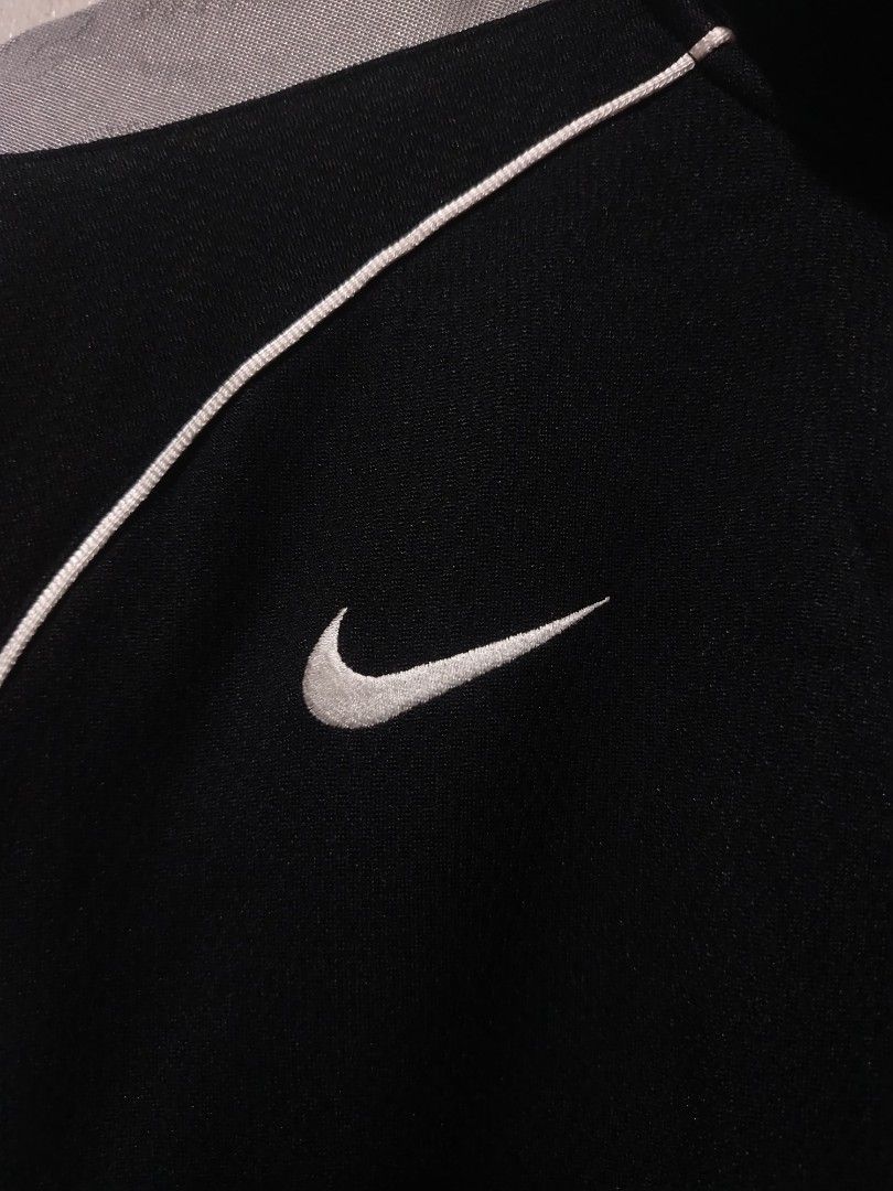 Nike Black Grey Track Jacket Full Zip (Category: Coats, Jackets and Outerwear) located in Rizal. Submitted by gmpastoffi75031 (Listing ID 1465312429, Image 2). Description: - Brand: Nike -dimes 21.5x27.5 - Colorway: Black and grey with contrast white piping - Features: Full zip front, stand-up collar, dual front pockets - Details: Ribbed cuffs and hem, embroidered white Swoosh logo on right chest - Condition: Excellent pre-loved condition - Mode 
