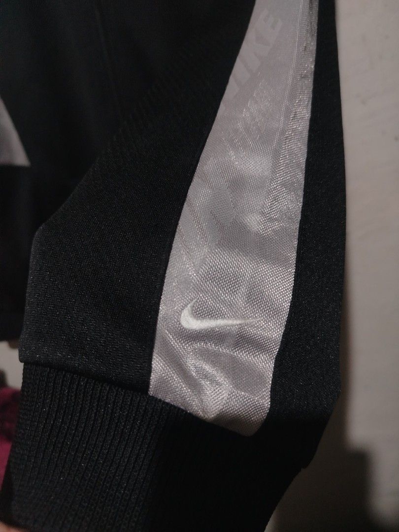 Nike Black Grey Track Jacket Full Zip (Category: Coats, Jackets and Outerwear) located in Rizal. Submitted by gmpastoffi75031 (Listing ID 1465312429, Image 3). Description: - Brand: Nike -dimes 21.5x27.5 - Colorway: Black and grey with contrast white piping - Features: Full zip front, stand-up collar, dual front pockets - Details: Ribbed cuffs and hem, embroidered white Swoosh logo on right chest - Condition: Excellent pre-loved condition - Mode 