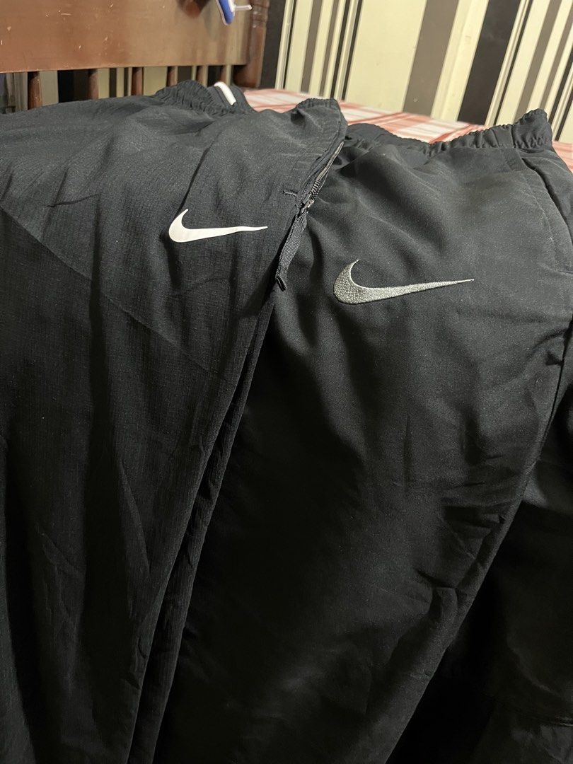 Nike Black Nylon Track Pants Sweatpants (Category: Joggers) located in Pasay City. Submitted by Oboyyy (Listing ID 1465205036, Image 3). Description: - Brand: Nike - Material: Classic lightweight nylon windbreaker - Color: Black - Features: Elastic waistbands, multiple styles and logo treatments available - Style: Great for lounging or streetwear fits - Availability: Multiple pairs in stock 799 - 999 each.