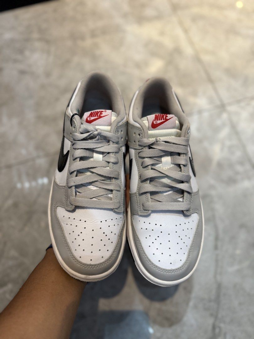 Nike Dunk Low Grey Patent Black Swoosh (Category: Sneakers) located in Bacolod City. Submitted by kitcarsonduff (Listing ID 1465323783, Image 2). Description: - Model: Nike Dunk Low - Colorway: White leather base with grey patent leather overlays and black patent swoosh - Details: Red Nike branding on the tongue tag and embroidered heel tab with a solid black rubber outsole - Condition: Clean soles with minimal wear - Style: Classic low-top baske