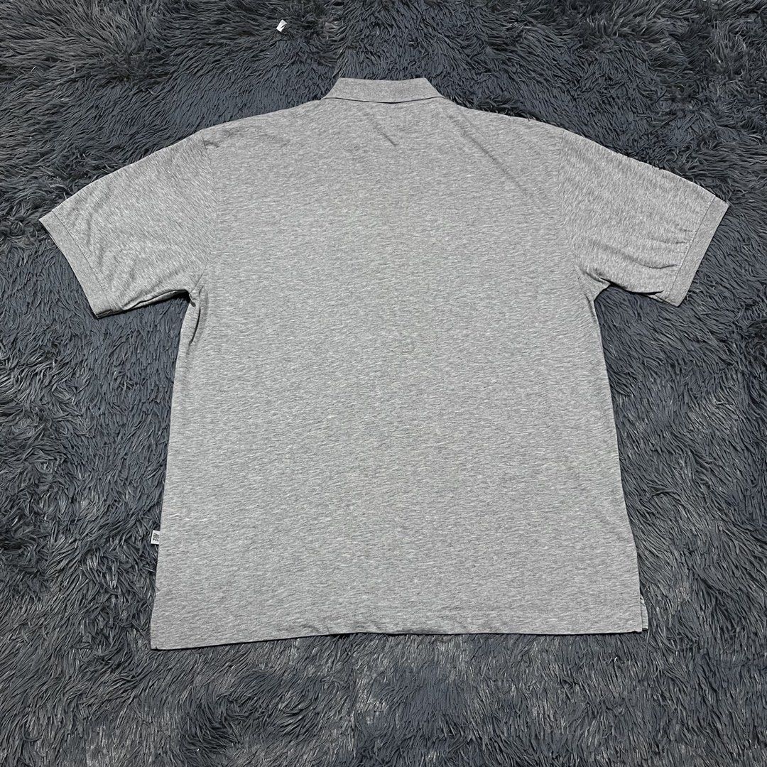 Nike Gray Polo Shirt (Category: Tshirts & Polo Shirts ) located in Batangas. Submitted by jaylord_g (Listing ID 1465282905, Image 2). Description: - 24x30 - XL - Brand: Nike - Style: Short-sleeve polo shirt with button placket and collar - Size: XXXL (Standard fit) - Color: Gray - Details: Small embroidered Nike swoosh logo on chest, unique zig-zag stitch detail across shoulders - Condition/Origin: Made in China, versatile and comfortable for eve