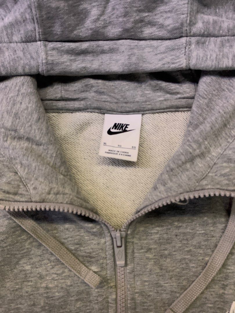 Nike Grey Zip-Up Hoodie (Category: Hoodies) located in Manila. Submitted by loyspalencia (Listing ID 1465263052, Image 3). Description: - Grey Nike zip-up hoodie - Classic Nike swoosh logo on chest - Full zip closure - Attached hood - Two convenient front pockets - Size: XL - Made in China - Dimes: W-25 / L- 28/ Sleeve- 23 - Size: Large - Execellent Condition.