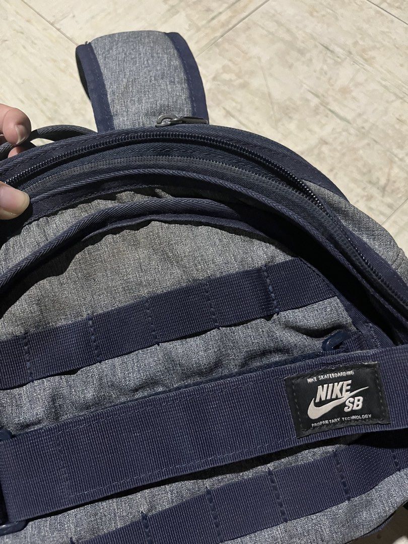Nike SB Courthouse Backpack Grey Navy (Category: Backpacks) located in Makati City. Submitted by byamary (Listing ID 1465314280, Image 3). Description: - Brand: Nike SB - Colorway: Heather grey and navy blue - Features front utility straps to secure a skateboard or jacket - Multiple zippered compartments with an internal mesh pocket - Comfortable padded shoulder straps for daily use - Condition: All zippers and buckles are fully functional - Perf