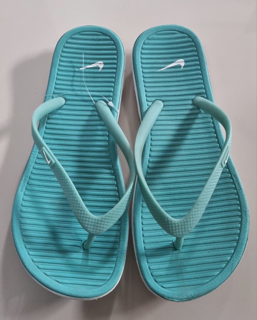 Nike Solarsoft Thong Flip Flops Turquoise Blue Size W7 (Category: Slippers and slides) located in Danao, Cebu. Submitted by CaxeCart (Listing ID 1465224843, Image 1). Description: - Brand: Nike - Style: Solarsoft thong sandals - Size: Women's US 7 / EUR 38 - Color: Teal with white accents and Nike swoosh logo - Features: Comfortable textured footbed, durable white outer sole - Origin: Made in Vietnam - Condition: Overall clean condition, minor di