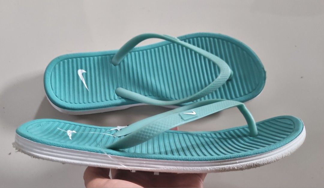 Nike Solarsoft Thong Flip Flops Turquoise Blue Size W7 (Category: Slippers and slides) located in Danao, Cebu. Submitted by CaxeCart (Listing ID 1465224843, Image 3). Description: - Brand: Nike - Style: Solarsoft thong sandals - Size: Women's US 7 / EUR 38 - Color: Teal with white accents and Nike swoosh logo - Features: Comfortable textured footbed, durable white outer sole - Origin: Made in Vietnam - Condition: Overall clean condition, minor di