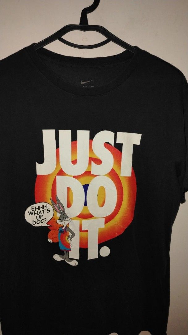 Nike Space Jam Bugs Bunny Just Do It T-Shirt (Category: Tshirts & Polo Shirts ) located in Cavite. Submitted by ukaynglahat (Listing ID 1465284143, Image 2). Description: - Brand: Nike - Design: Space Jam crossover with Bugs Bunny, target logo, and 'Ehhh What's Up Doc?' quote - Color: Black with white graphic text - Size: S (Standard fit) - Material: 100% cotton - Condition: Regular wear with minimal fading - Style: Crew neck, short sleeves.
