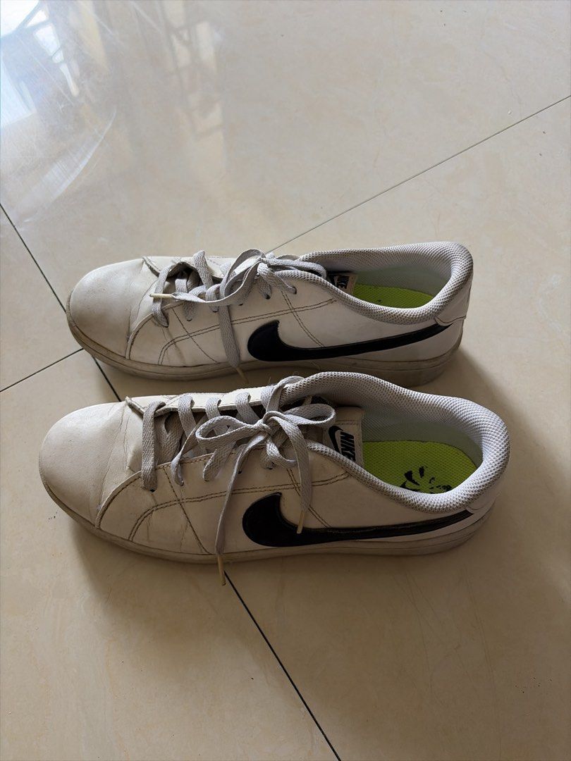 Nike White and Black Sneakers (Category: Sneakers) located in Manila. Submitted by rich028 (Listing ID 1465214312, Image 1). Description: - Brand: Nike - Color: White with black swoosh and bright green insoles - Details: Grey laces, metal eyelets, and textured rubber outsoles - Condition: Normal leather creasing from previous wear - Style: Classic and comfortable everyday sneakers.