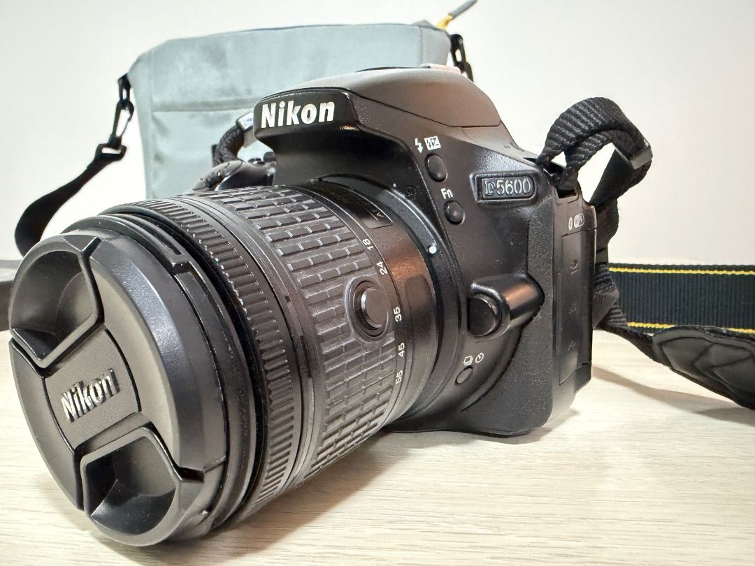 Nikon D5600 DSLR Camera Bundle with Bag and Accessories (Category: Cameras) located in Quezon City. Submitted by ikokia (Listing ID 1465315237, Image 2). Description: - Model: Nikon D5600 DSLR Camera - Lents Nikon 18-55mm - Shutter Count: 20,998 shots - Ideal starter kit for aspiring photographers and upgraders - Includes grey shoulder bag for easy transport - Comes with extra lens hoods - Includes battery charger - Maintenance tools included: ai