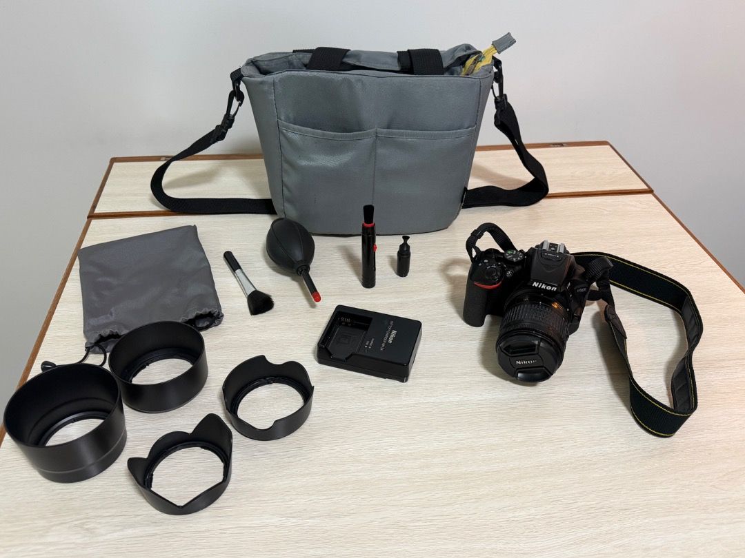 Nikon D5600 DSLR Camera Bundle with Bag and Accessories (Category: Cameras) located in Quezon City. Submitted by ikokia (Listing ID 1465315237, Image 1). Description: - Model: Nikon D5600 DSLR Camera - Lents Nikon 18-55mm - Shutter Count: 20,998 shots - Ideal starter kit for aspiring photographers and upgraders - Includes grey shoulder bag for easy transport - Comes with extra lens hoods - Includes battery charger - Maintenance tools included: ai