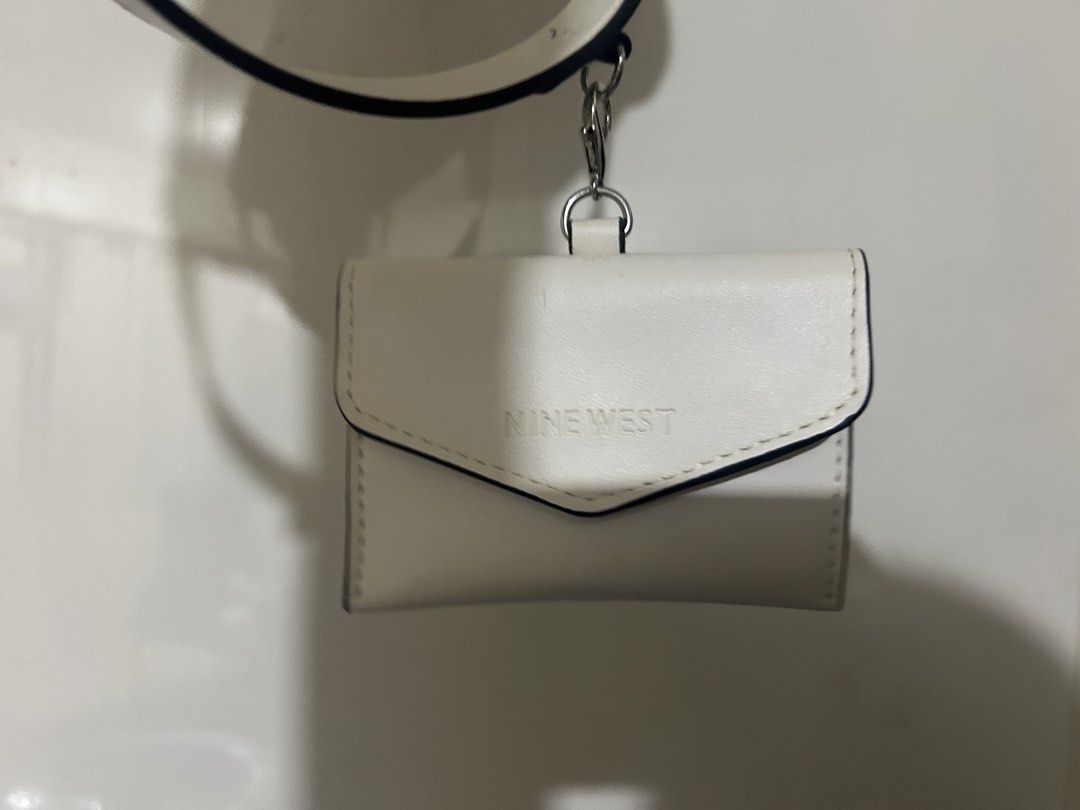 Nine West White Mini Handbag with Satchel (Category: Shoulder Bags) located in Paranaque City. Submitted by inkling19 (Listing ID 1465296986, Image 2). Description: - Brand: Nine West - Color: White - there is like streak/dirt on the strap but can be possibly be cleaned Original price was 3200.