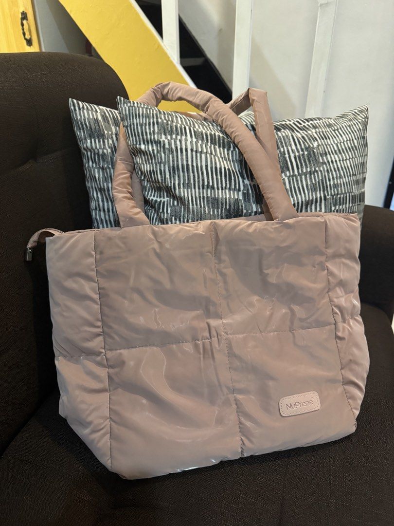 Nuprene Tote Bag (Category: Tote Bags) located in Caloocan City. Submitted by aeslaehc (Listing ID 1465325440, Image 3). Description: Nupre Floofa Puffer Tote Available in Rose Gold and Brown color > In good condition > Can fit ipad pro 11 inches, yellowpad, and aquaflask > Has two compartments & zipper inside Take all for 500 Payment thru GCASH or Cash if meet uo.