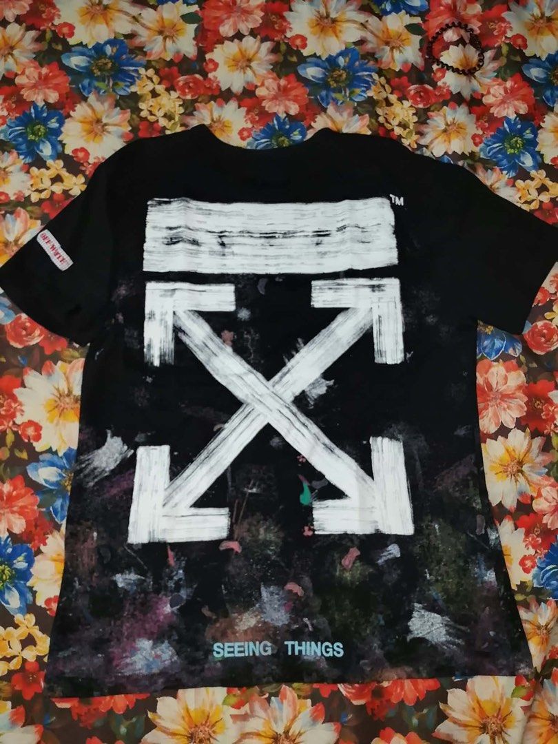 Off-White Seeing Things Galaxy Spray Paint T-Shirt (Category: Shirts) located in Talisay. Submitted by rjthriftfinds (Listing ID 1465329431, Image 1). Description: - Brand: Off-White (Seeing Things Collection) - Color: Black with multi-color galaxy print - Design: Large white diagonal arrows on the back, small Off logo on the chest - Material: 100% premium cotton - Fit: Classic crewneck - Condition: Brand new with main label and wash tags attache