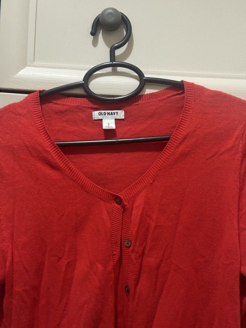Old Navy Red Button-Up Cardigan Size M (Category: Coats, Jackets and Outerwear) located in Makati City. Submitted by thingsoncelovedph (Listing ID 1465196262, Image 2). Description: - Brand/Style: Old Navy women's cardigan - Size: Medium - Color: Bright red with brown buttons - Features: V-neckline, long sleeves, ribbed hem and cuffs - Condition: Good overall, with a faint dark spot near the front button placket (see close-up photo) - Perfect lay