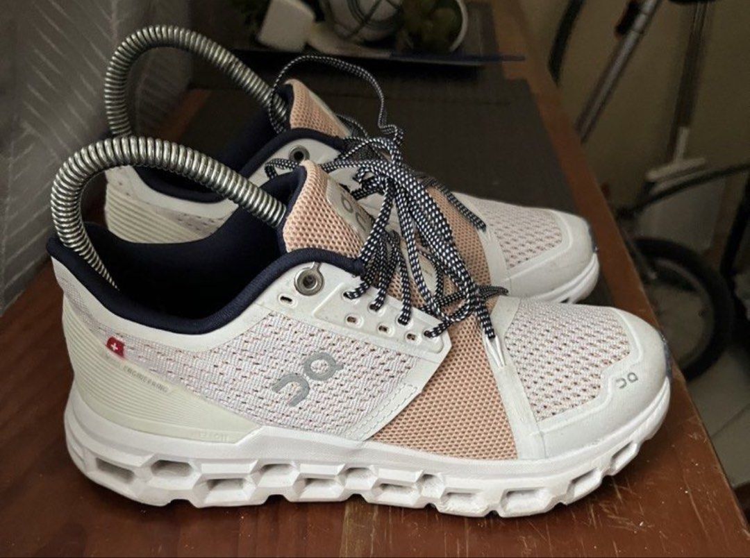 On Cloud Sneaker White Pink Navy (Category: Sneakers) located in Caloocan City. Submitted by ylieramae201821 (Listing ID 1465283459, Image 2). Description: - Brand: On Cloud Running Shoes - Colorway: White upper with peach pink mesh and navy blue collar lining - Features: Swiss engineering tag, CloudTec sole with black traction pads, and black/white dotted laces with metal eyelets - Condition: Moderate wear on bottom treads and a tiny mark on the