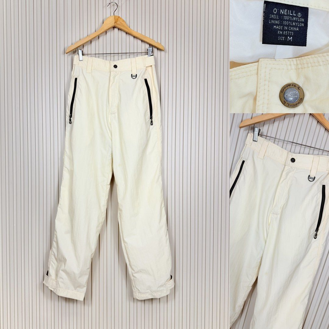 O'Neill White Nylon Snow Pants Size M (Category: Jeans) located in Pasig City. Submitted by trendapparelph (Listing ID 1465255555, Image 1). Description: - Brand: O'Neill - Item: Winter Snow Pants - Color: Cream White - Size: Medium (M) - Material: 100% Nylon (Shell and Lining) - Features: Branded button waist closure, secure zipper pockets on both sides, and a metal D-ring loop near the left pocket.
