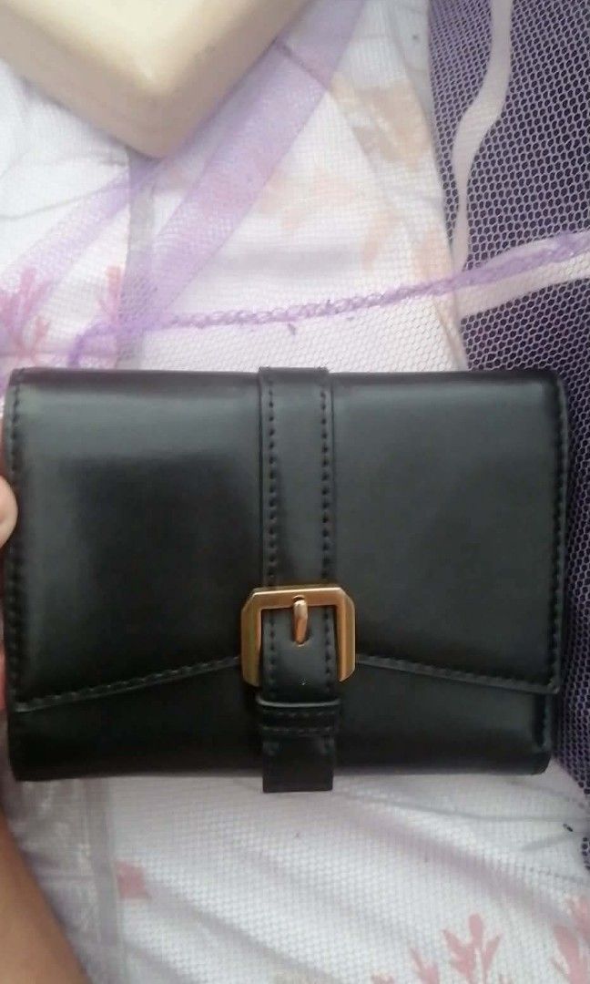 Original Charles & Keith Black Tri-fold Wallet - 100% Authentic (Category: Wallets & Card holders) located in Manila. Submitted by roseannlmn66895 (Listing ID 1464235567, Image 1). Description: *CHARLES & KEITH Wallet - Black* Tri-fold long wallet, black color, gold buckle and gold zipper. Faux leather, makinis, no bakbak. May card slots, bill compartment, coin zipper. With CHARLES & KEITH engrave sa zipper at emboss sa loob. Good as new, malinis