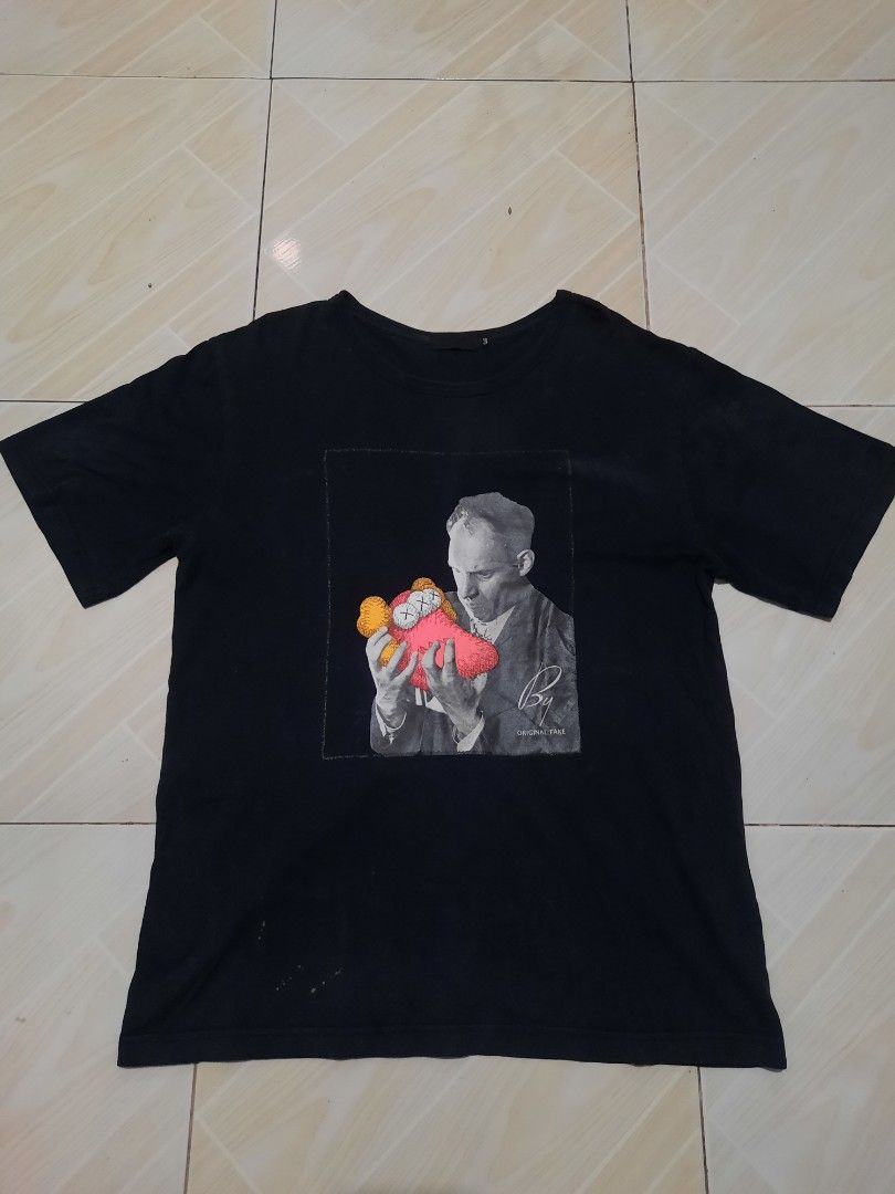kaws graphic tee (Category: Tshirts & Polo Shirts ) located in Tarlac. Submitted by thryftstash (Listing ID 1465352799, Image 1). Description: dimes: 28-21 3 on tag issue: minimal discoloration & small stain sf not included tarlac loc j&t and lbc courier.
