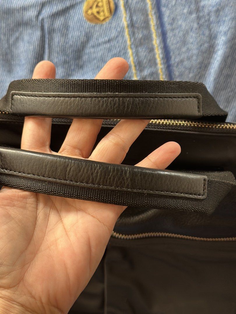 Paul Smith Black Nylon Leather Trim Briefcase (Category: Briefcases) located in Batangas. Submitted by enyahsnivl56498 (Listing ID 1465180584, Image 3). Description: - Brand: Paul Smith - Material: Durable black nylon with textured leather accents - Hardware: Premium gold-tone hardware with custom Paul Smith zipper pulls and D-rings - Handles: Twin carry handles with comfortable leather grip sections - Interior: Multiple compartments, slip pocket