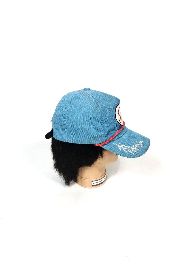 Peaceminusone Corduroy Cap Blue (Category: Caps & Hats) located in Manila. Submitted by callmetin (Listing ID 1465172588, Image 2). Description: - Brand: Peaceminusone - Material: Bright blue corduroy - Details: White oval logo patch with red/yellow embroidery, red braided rope across the brim - Accents: White embroidered leaf graphics on the side panels and signature daisy embroidery on the back - Fit: Adjustable leather strap closure with metal