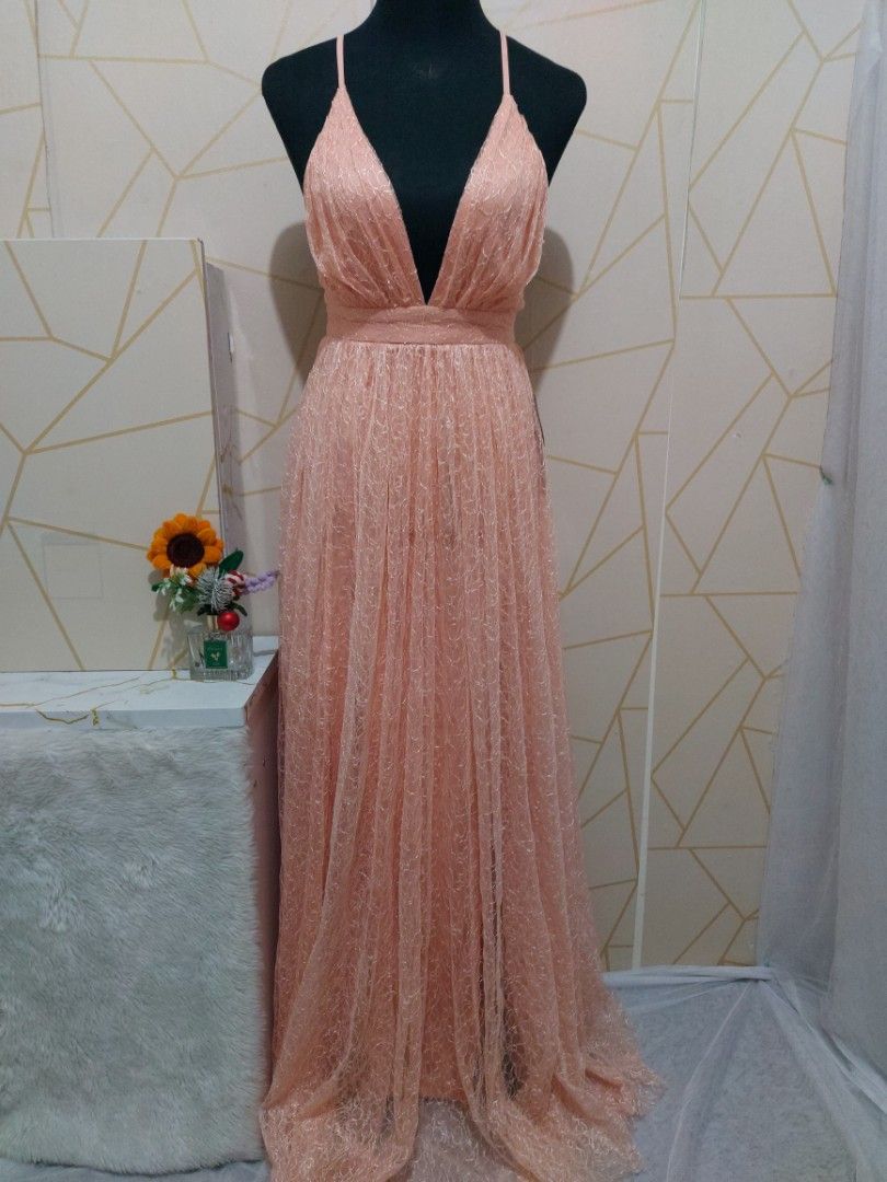 Peach Pink Long Maxi Dress Deep V-Neck Open Back (Category: Dresses) located in Manila. Submitted by jollyann_b1990 (Listing ID 1465314807, Image 3). Description: - Color: Peach pink - Design: Deep V-neck, thin spaghetti straps, and crossed back straps with zipper closure - Skirt: Fitted waistband flowing into a pleated tulle skirt with subtle sparkle and a small train - Length: Floor-length - Material: Lightweight and comfortable fabric - waist-