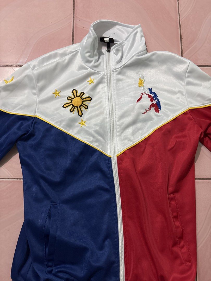 Pilipinas Philippines National Flag Track Jacket (Category: Coats, Jackets and Outerwear) located in Binan City. Submitted by fashion_claims (Listing ID 1465251847, Image 1). Description: - Philippine flag color blocking (white, blue, red) with yellow piping - Embroidered sun, stars, and map details on the chest - "PILIPINAS" text and star embroidered on the back - Full zip closure with a stylish stand-up collar - Great for national pride, cultur