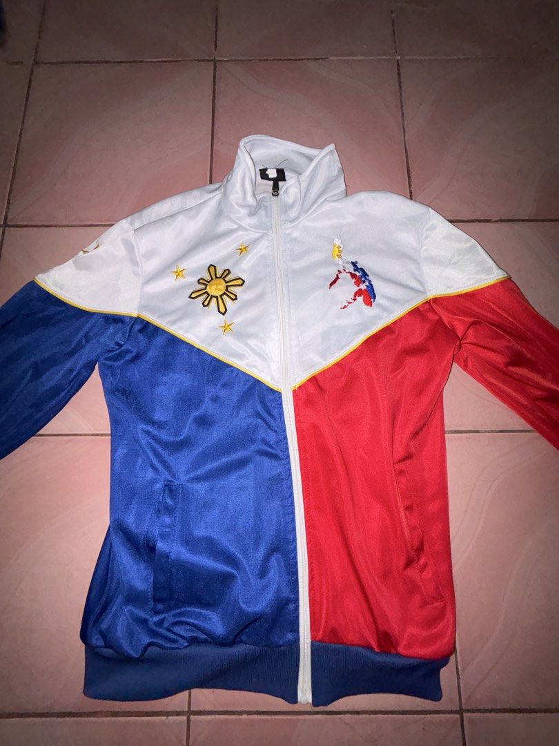 Pilipinas Philippines National Flag Track Jacket (Category: Coats, Jackets and Outerwear) located in Binan City. Submitted by fashion_claims (Listing ID 1465251847, Image 2). Description: - Philippine flag color blocking (white, blue, red) with yellow piping - Embroidered sun, stars, and map details on the chest - "PILIPINAS" text and star embroidered on the back - Full zip closure with a stylish stand-up collar - Great for national pride, cultur