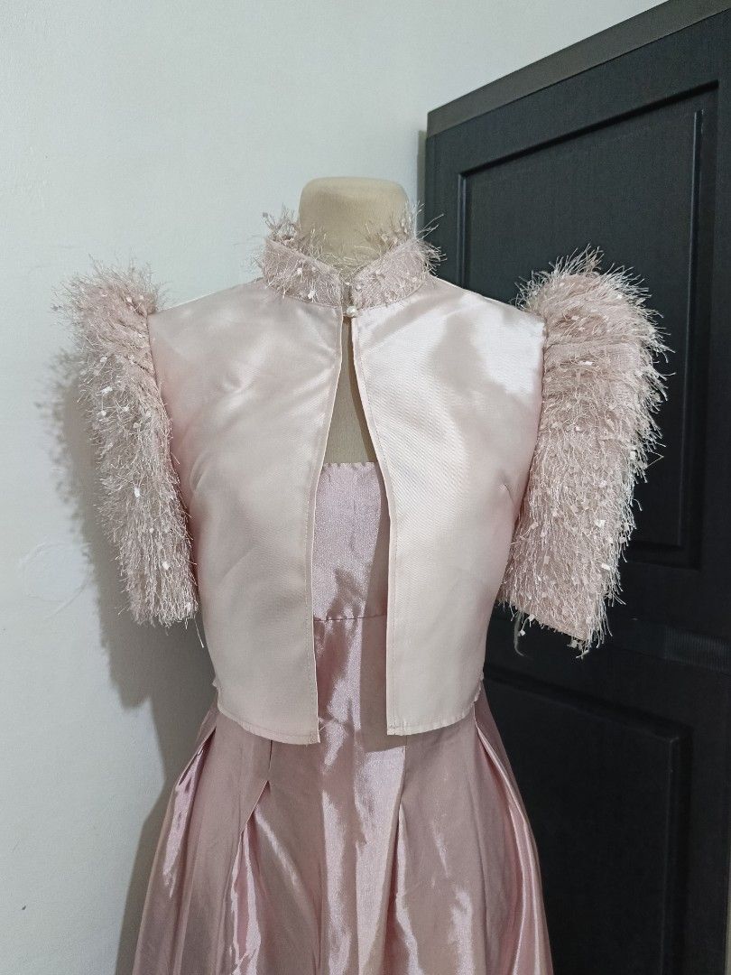 Pink Bolero (Category: Coats, Jackets and Outerwear) located in Cabanatuan. Submitted by lyxyx (Listing ID 1465306888, Image 2). Description: - Matching pink dress and cropped jacket set - High neckline with fuzzy trim and pearl button closure - Jacket features matching fuzzy textured short sleeves - Dress includes a structured bodice and pleated skirt - Smooth, shiny fabric finish - Perfect formal or event outfit.