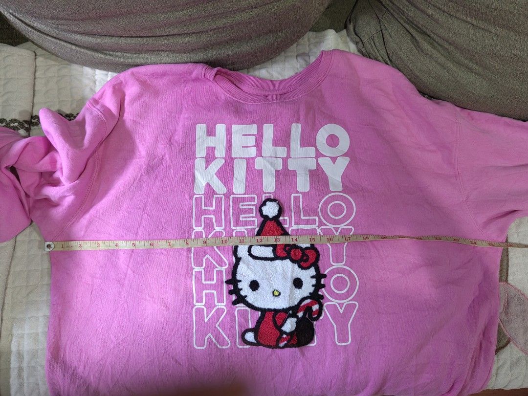 Pink Hello Kitty Sweatshirt Hybrid Apparel (Category: Coats, Jackets and Outerwear) located in Quezon City. Submitted by chicberry (Listing ID 1464766569, Image 2). Description: - Vibrant bright pink Kitty sweatshirt - Festive fuzzy Santa hat detail on the front - Bold repeating white " Kitty" text - Cozy soft fleece interior for warmth - Classic ribbed collar, cuffs, and hem - Comfortable tagless collar by Hybrid Apparel.