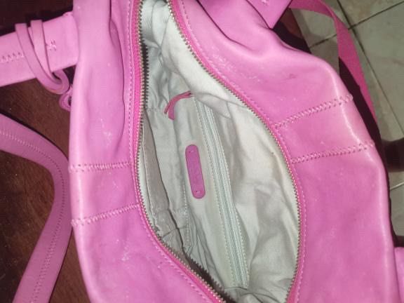 Pink Leather Shoulder Bag with Zippers (Category: Shoulder Bags) located in Manila. Submitted by geminibibo (Listing ID 1465363313, Image 3). Description: - Color: Bright pink - Material: Genuine leather with normal wear - Hardware: Silver-tone accents - Straps: Dual top handles for shoulder or hand carry - Exterior: Front zipper pockets and decorative stitching - Interior: Fabric lining with one inner zipper pocket and brand tag - Usage: Spaciou