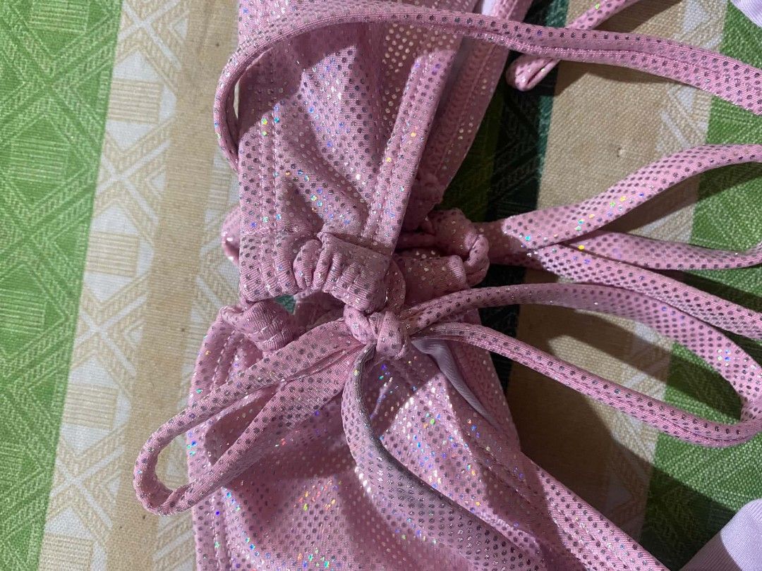 Pink Sparkly Bikini Bottom Size S (Category: Bikinis & Swimsuits) located in Manila. Submitted by hakuuu_0027 (Listing ID 1465377255, Image 3). Description: - Size: Small - Color/Design: Pink glitter with a shiny holographic dot pattern - Fit: Adjustable side tie closures - Comfort: Fully lined interior - Material: 92% polyester, 8% spandex - Condition: Brand new.