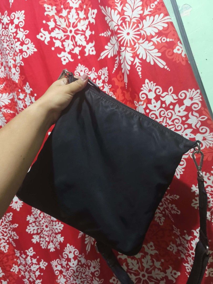 Prada Black Nylon Crossbody Bag (Category: Luxury Bags & Wallets) located in Pasig City. Submitted by pingsrarefinds (Listing ID 1465252961, Image 2). Description: - Authentic black Prada crossbody bag made from durable nylon - Convenient exterior front zip pocket and secure top zipper closure - Adjustable black shoulder strap with sleek silver-tone hardware - Signature Prada jacquard fabric interior lining - Practical inner zip pocket with iconi