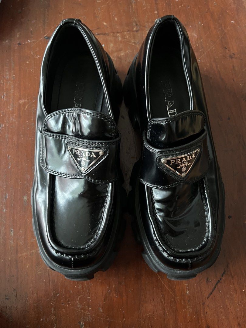 Prada Brushed Leather Monolith Loafers Black (Category: Loafers) located in Manila. Submitted by dailygetup (Listing ID 1465330493, Image 1). Description: - Brand: Prada - Model: Monolith Brushed Leather Loafers - Color: Black - Features: Iconic enamel triangle logo, chunky lug sole, embossed logo on heel and tread, slip-on design - Condition: Excellent pre-loved condition with minimal creasing on the vamp - Inlining: Prada silver lettering stamp