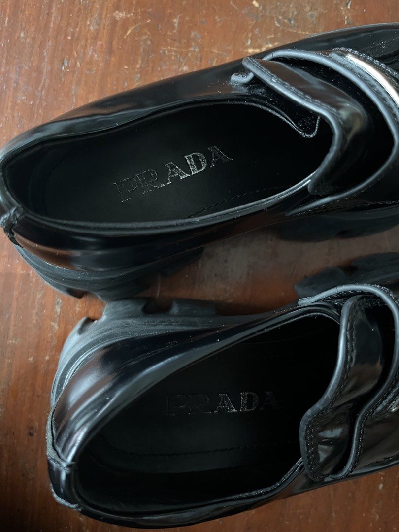 Prada Brushed Leather Monolith Loafers Black (Category: Loafers) located in Manila. Submitted by dailygetup (Listing ID 1465330493, Image 3). Description: - Brand: Prada - Model: Monolith Brushed Leather Loafers - Color: Black - Features: Iconic enamel triangle logo, chunky lug sole, embossed logo on heel and tread, slip-on design - Condition: Excellent pre-loved condition with minimal creasing on the vamp - Inlining: Prada silver lettering stamp