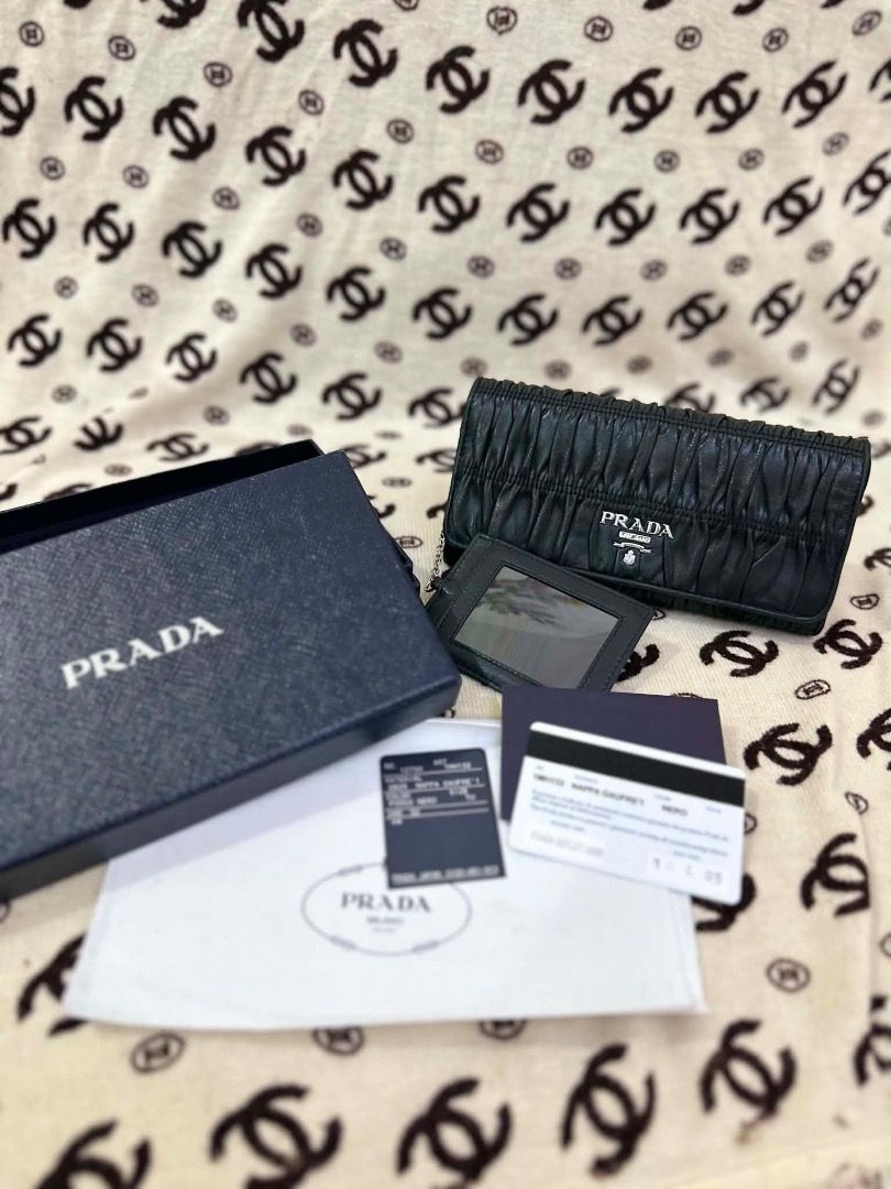 Prada Nappa Gaufre 1 Black Leather Long Wallet (Category: Luxury Bags & Wallets) located in San Pedro. Submitted by silverlion-4d46 (Listing ID 1465213875, Image 3). Description: - Authentic Prada long wallet in luxurious black nappa gaufre leather - Features a soft pleated texture, silver-tone hardware, and iconic front logo lettering - Includes a matching cardholder with a convenient clear ID window - Spacious interior equipped with card slots,