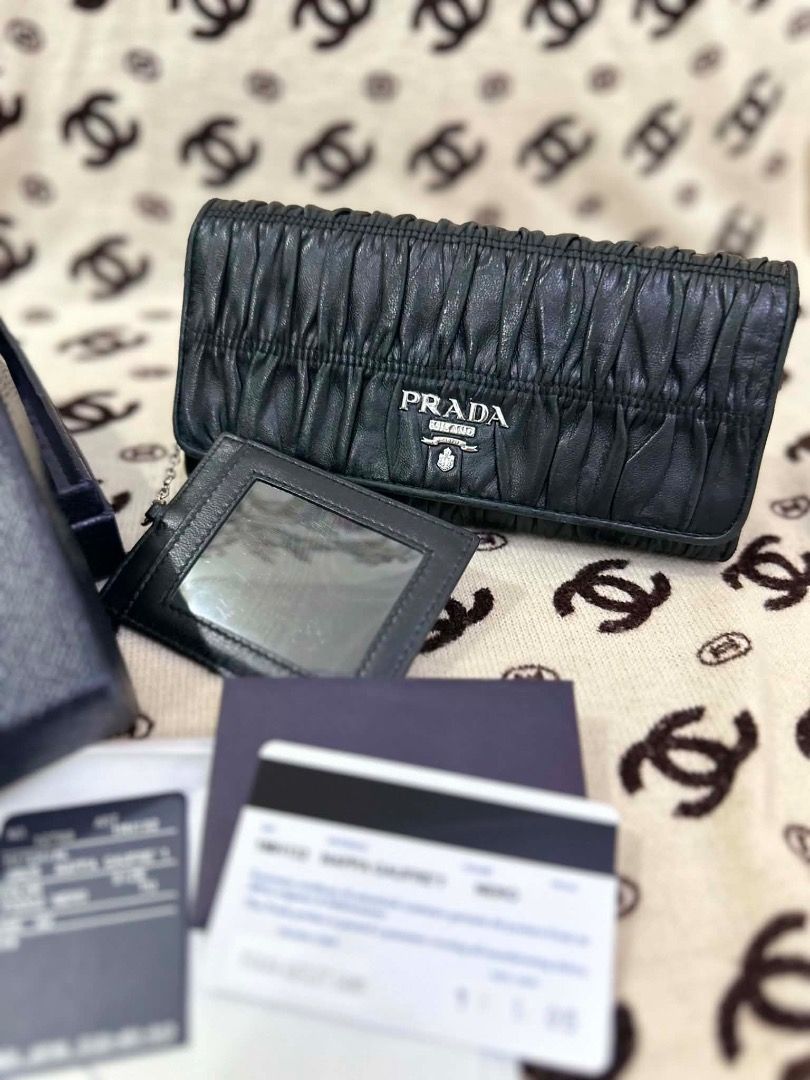 Prada Nappa Gaufre 1 Black Leather Long Wallet (Category: Luxury Bags & Wallets) located in San Pedro. Submitted by silverlion-4d46 (Listing ID 1465213875, Image 1). Description: - Authentic Prada long wallet in luxurious black nappa gaufre leather - Features a soft pleated texture, silver-tone hardware, and iconic front logo lettering - Includes a matching cardholder with a convenient clear ID window - Spacious interior equipped with card slots,