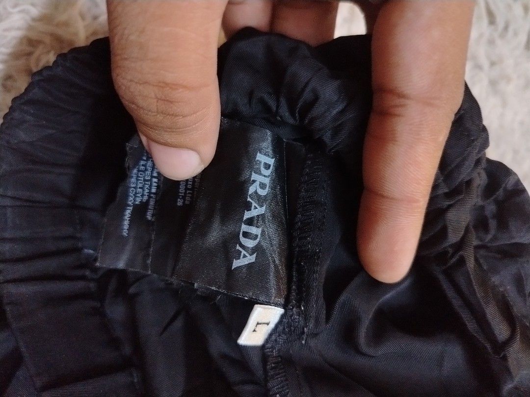 PRADA Re-Nylon Short (Category: Shorts) located in Roxas City. Submitted by hd_thriftshop (Listing ID 1465184644, Image 3). Description: black Prada Re-Nylon shorts, accented with the brand's signature enameled metal triangle logo on the leg Dimension WIDTH : 28-34 LENGTH : 13.