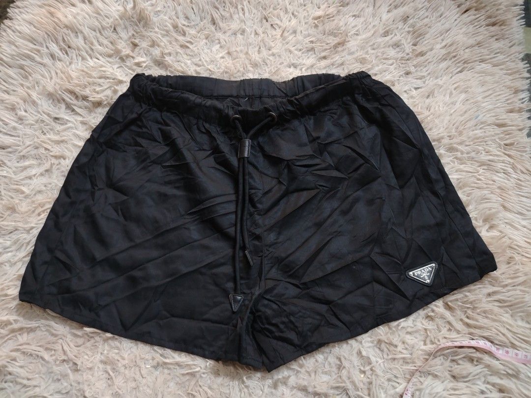 PRADA Re-Nylon Short (Category: Shorts) located in Roxas City. Submitted by hd_thriftshop (Listing ID 1465184644, Image 1). Description: black Prada Re-Nylon shorts, accented with the brand's signature enameled metal triangle logo on the leg Dimension WIDTH : 28-34 LENGTH : 13.
