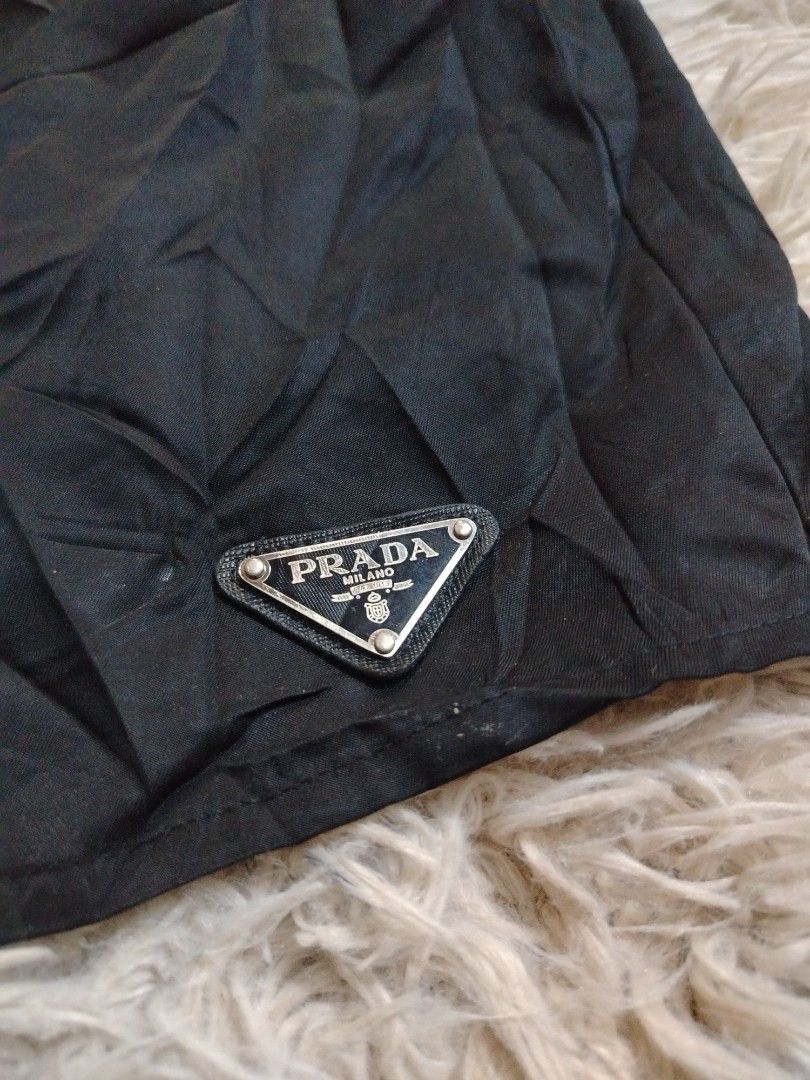 PRADA Re-Nylon Short (Category: Shorts) located in Roxas City. Submitted by hd_thriftshop (Listing ID 1465184644, Image 2). Description: black Prada Re-Nylon shorts, accented with the brand's signature enameled metal triangle logo on the leg Dimension WIDTH : 28-34 LENGTH : 13.