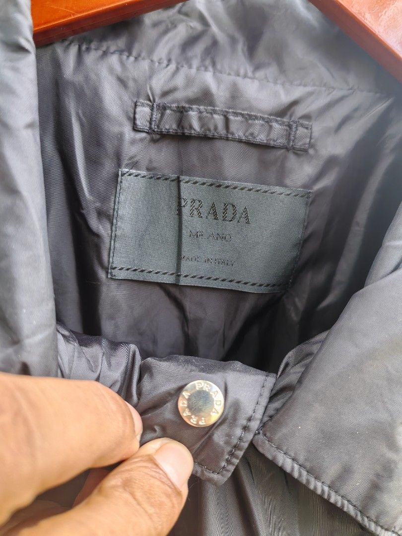 Prada windbreaker button down (Category: Luxury Apparel) located in Iloilo. Submitted by luxury.ilo1984 (Listing ID 1465295118, Image 3). Description: Thrifted Ukay Source Almost new condition No issue 10/10 color rate & conditions Size 54 on tag Dimes 24by30 Best fit large to XL Black colorway.