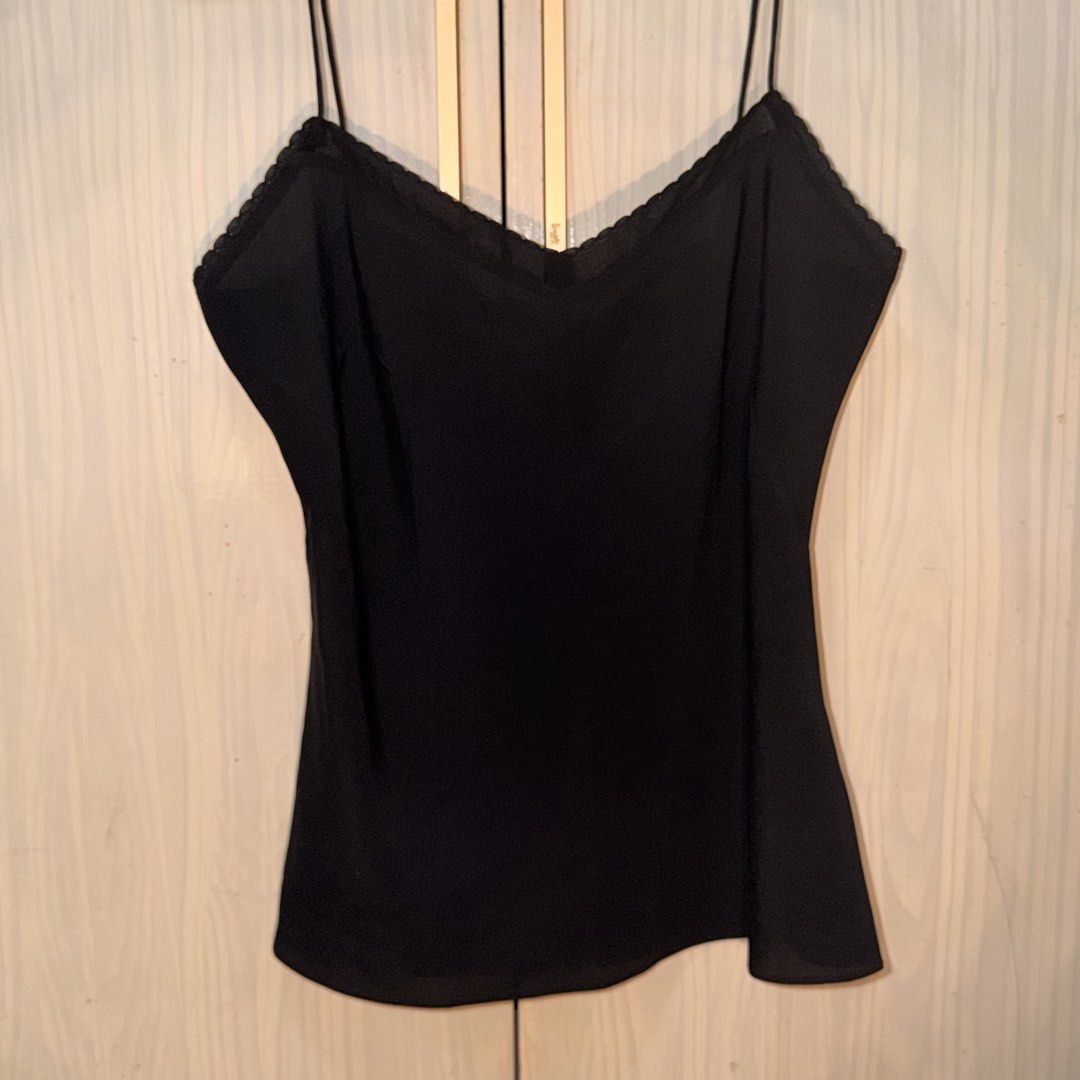 PRELOVED- BLACK CAMISOLE TOP 🖤 (Category: Sleeveless) located in Abucay. Submitted by littlefindsbyb (Listing ID 1465381789, Image 3). Description: ✨ PRELOVED BLACK CAMISOLE TOP ✨ Elegant and versatile wardrobe staple — perfect for layering or wearing on its own. Easy to dress up or down for any occasion. 📏 MEASUREMENTS (laid flat): • Chest: ~17–18” • Length: ~16–17” • Fit: Flowy / Relaxed Cut ✨ DETAILS: • Classic black color • Thin spaghetti s